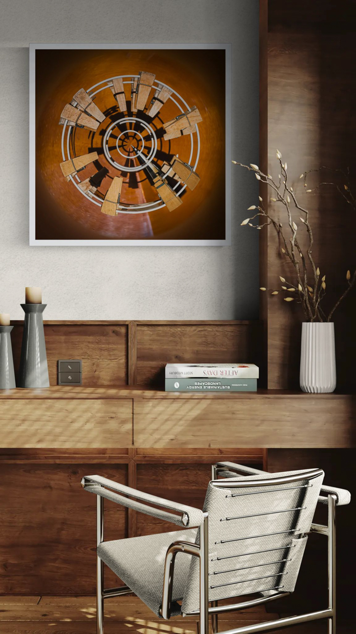 Simulated indoor display: *Planet of Clothespins* by Paul Marnef, a square framed artwork hung above a wooden cabinet