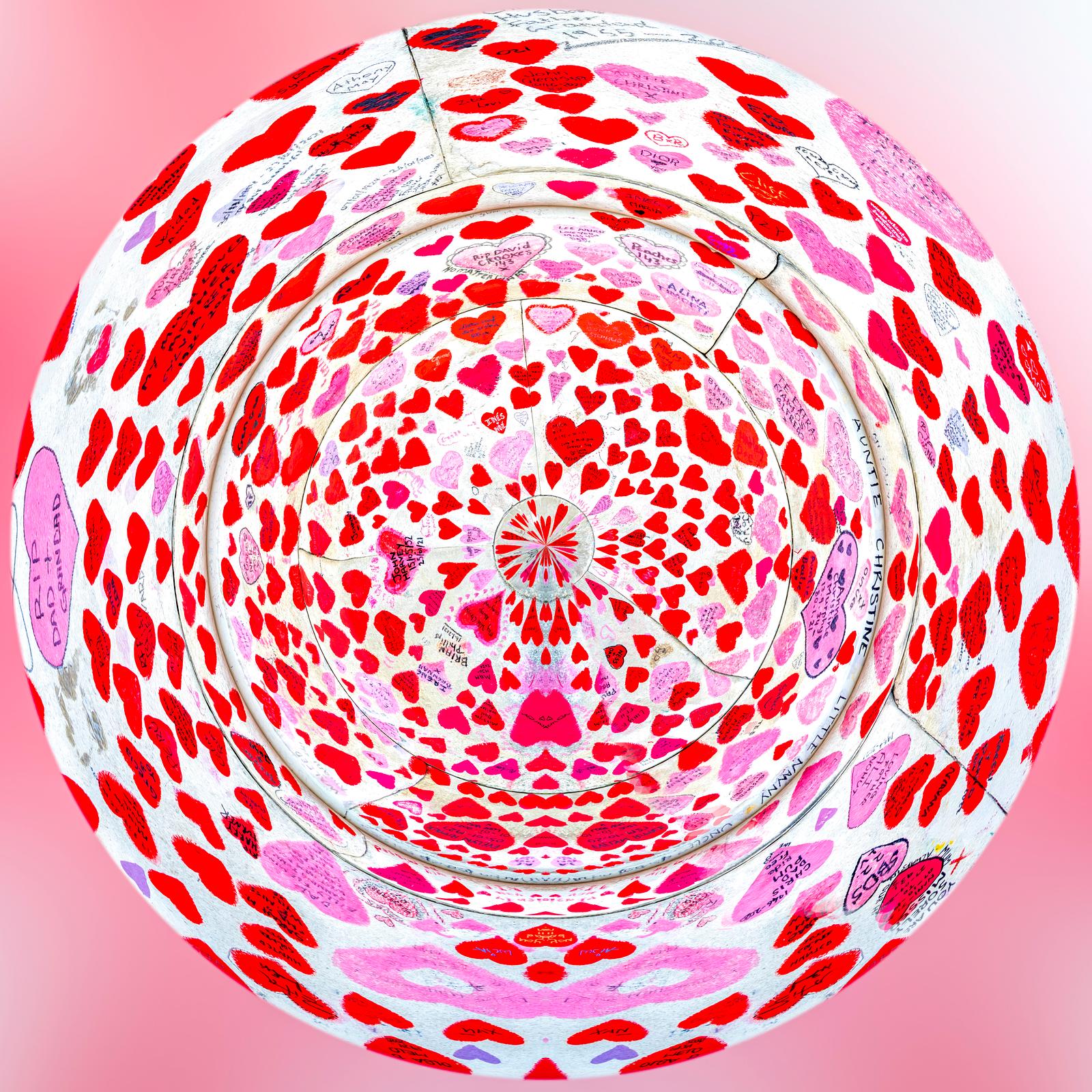 Tribute to Life and Absence, red and pink hearts rearranged to form an imaginary planet, photograph by Paul Marnef