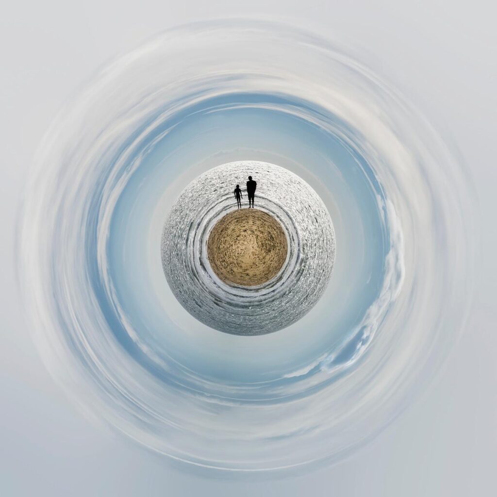 Two figures stand on a small sandy island, surrounded by an ocean of shimmering waves forming rings against a swirling sky.