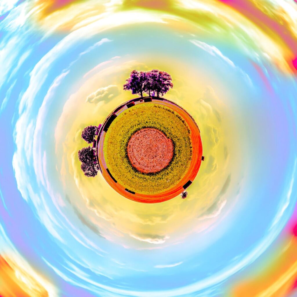 A field of flowers forming a central circle beneath a blue and yellow sky, distorted by an intense spiral effect.