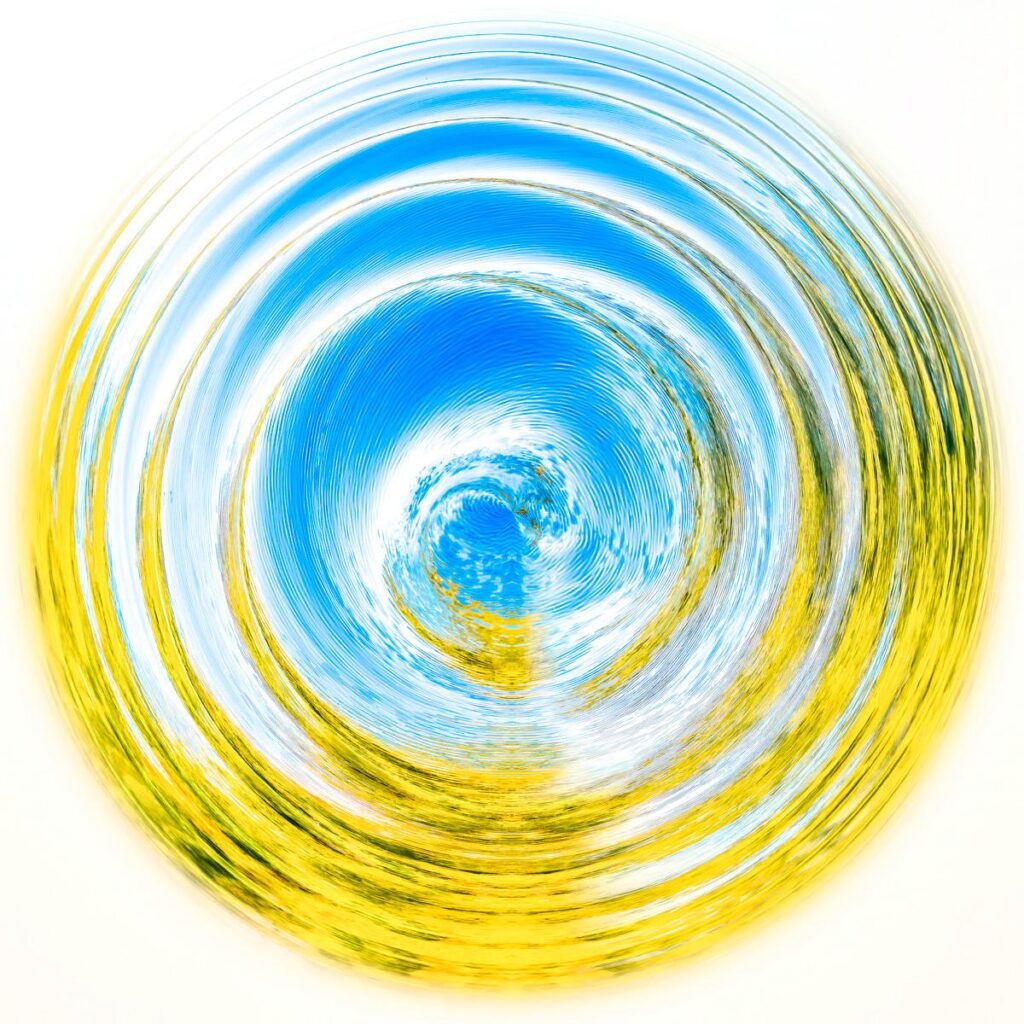 An abstract swirl of concentric curves in yellow, green, white and bright blue against a light background, evoking a wave.