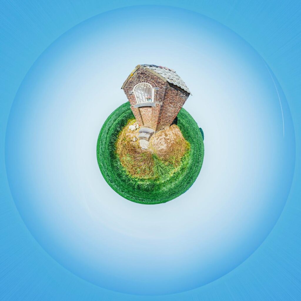 A small brick cottage perched on a hill of grass and moss, floating in the centre of a vast, blue-hued sky.